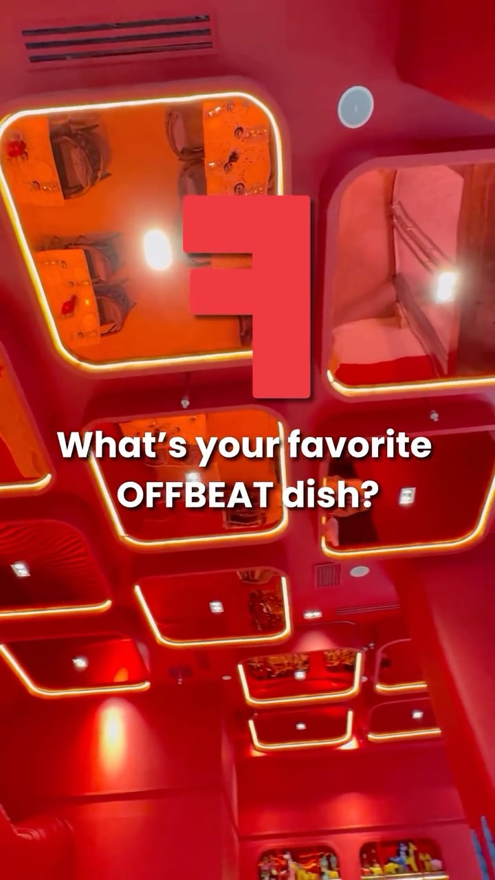 Offbeat Bistro interior with neon tube ceiling lights